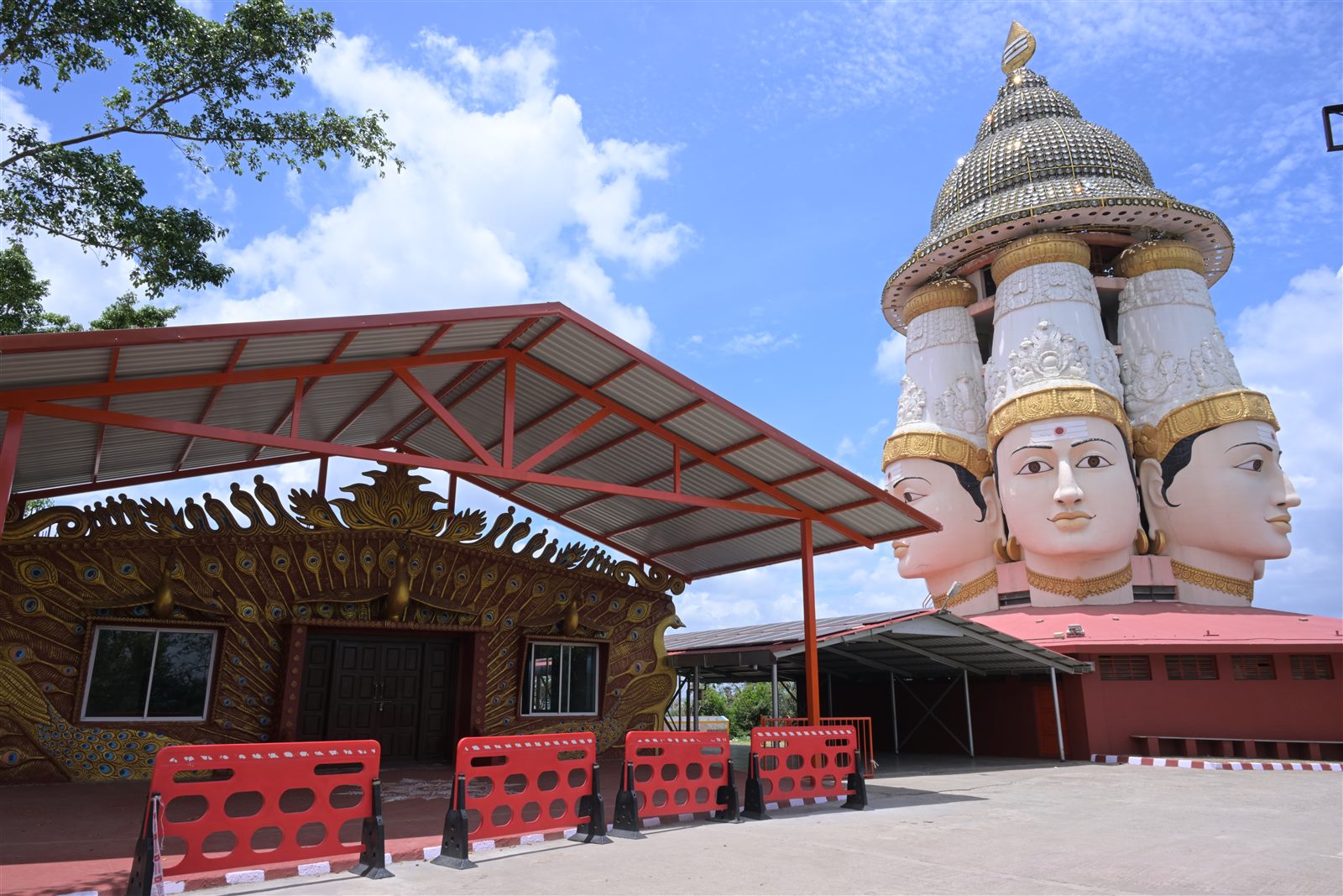 Peacock-motif facade beside temple shrine